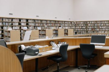 black office rolling chair beside brown wooden table